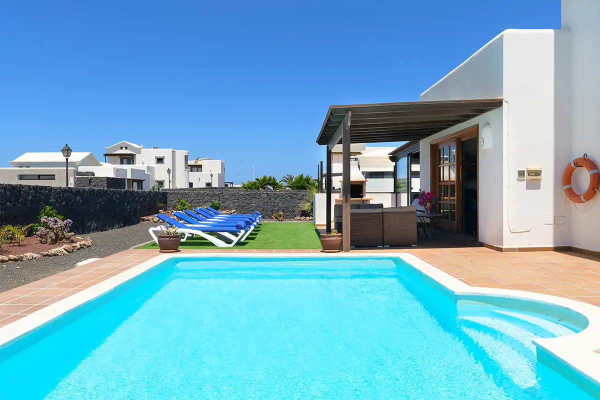 Außenpool mit Sonnenbereich und Holzpergola im Hintergrund bei Hipoclub Villa Aguamarina 29