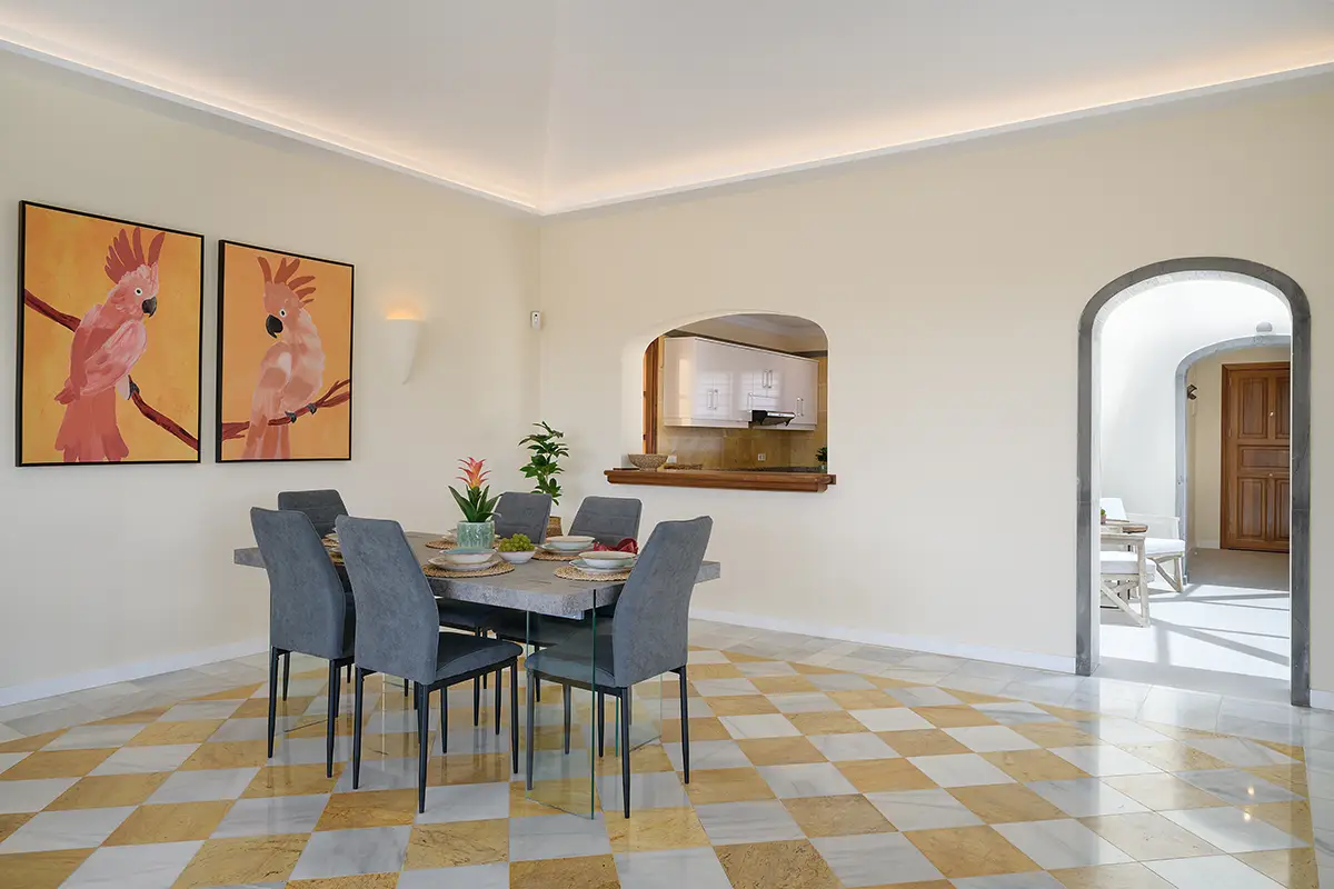Dining area with pass-through window to the kitchen at Villa Faro Park 189 Hipoclub