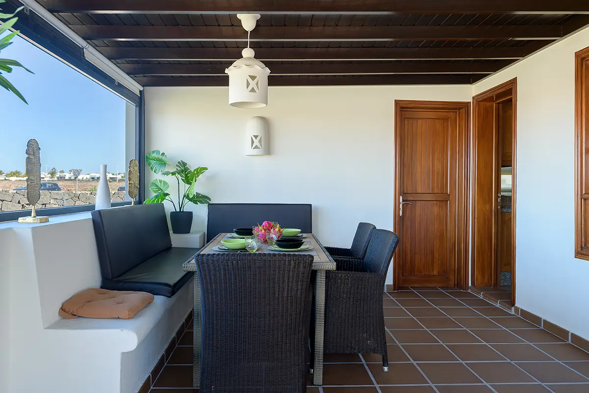 Dining area on the covered terrace at Hipoclub Villa Aguamarina 1