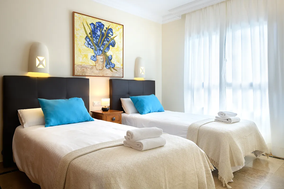 Towels and bed linen in the room at Hipoclub Villa Aguamarina 1
