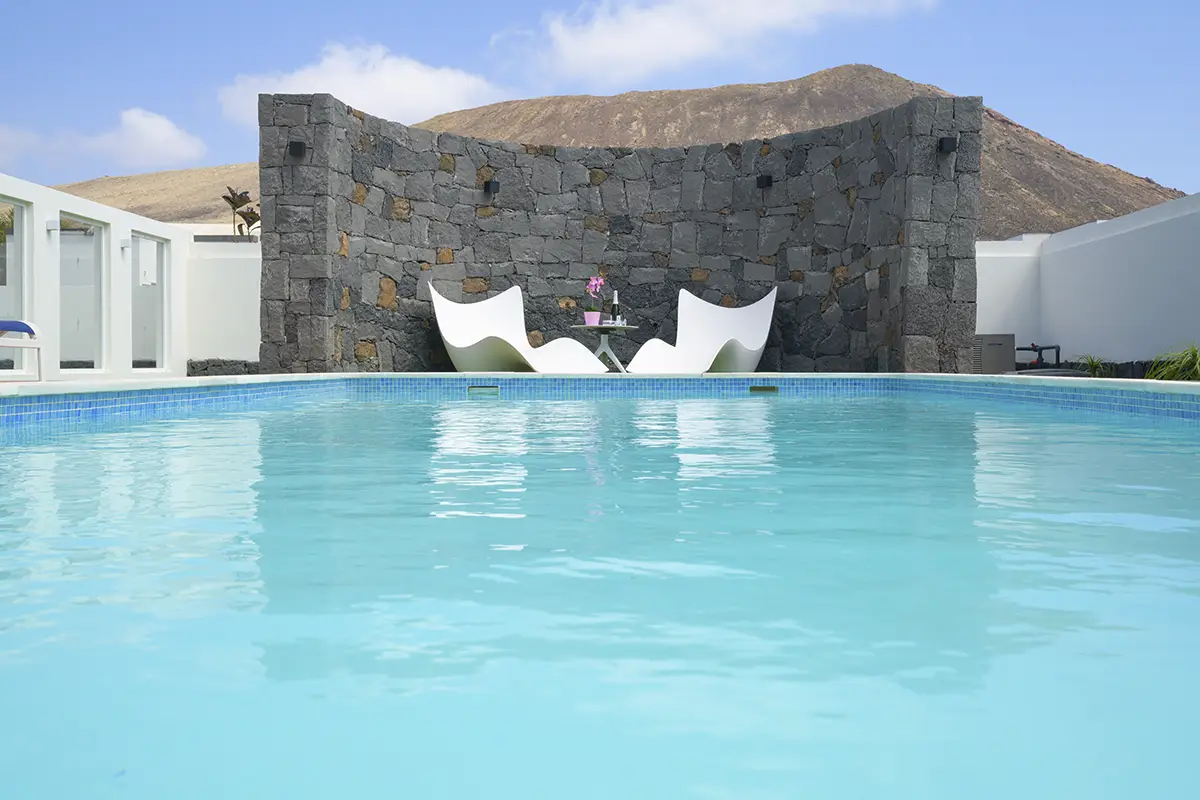 Ruhebereich am Steinmauer-Pool der Villa Alisios Hipoclub