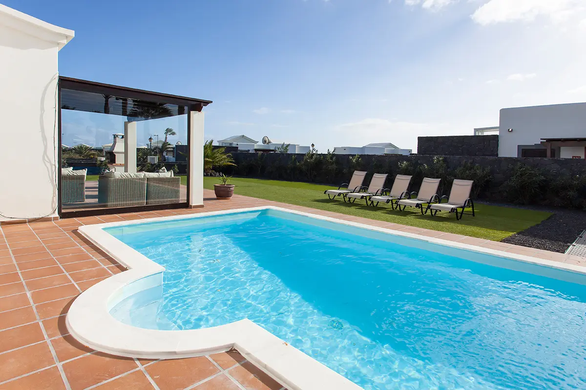 Swimming pool with sunbathing area at Hipoclub Villa Zafiro 34