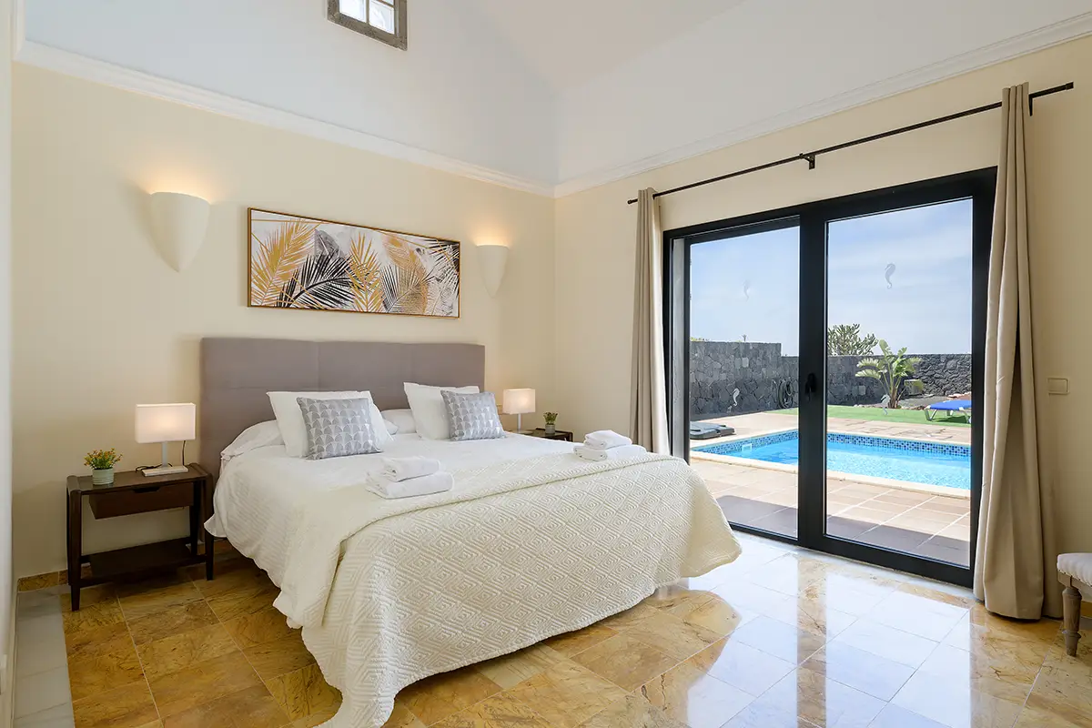 Master bedroom with pool view at Villa Faro Park 189 Hipoclub