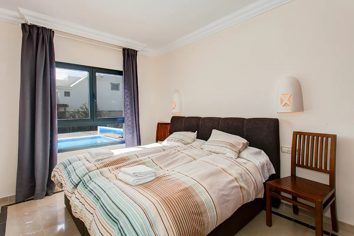 Double bedroom with pool views at Hipoclub Villa Zafiro 34