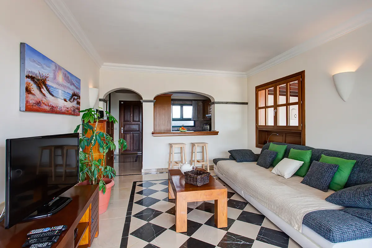 Living room with sofa and television at Hipoclub Villa Zafiro 34