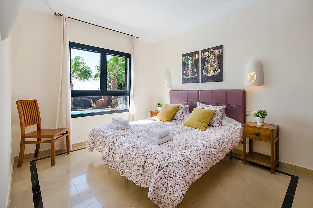 Garden-view bedroom at Villa Ámbar Hipoclub