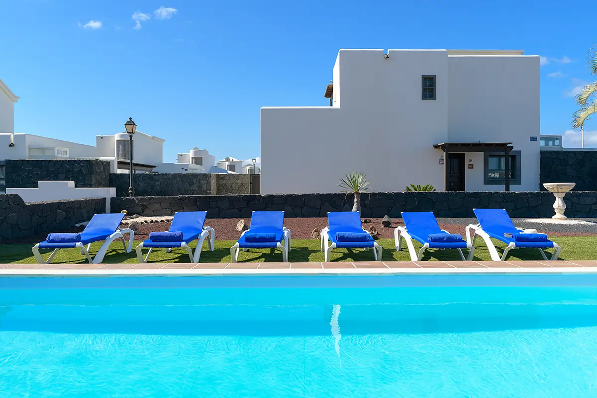 Sun loungers next to the pool at Hipoclub Villa Aguamarina 1