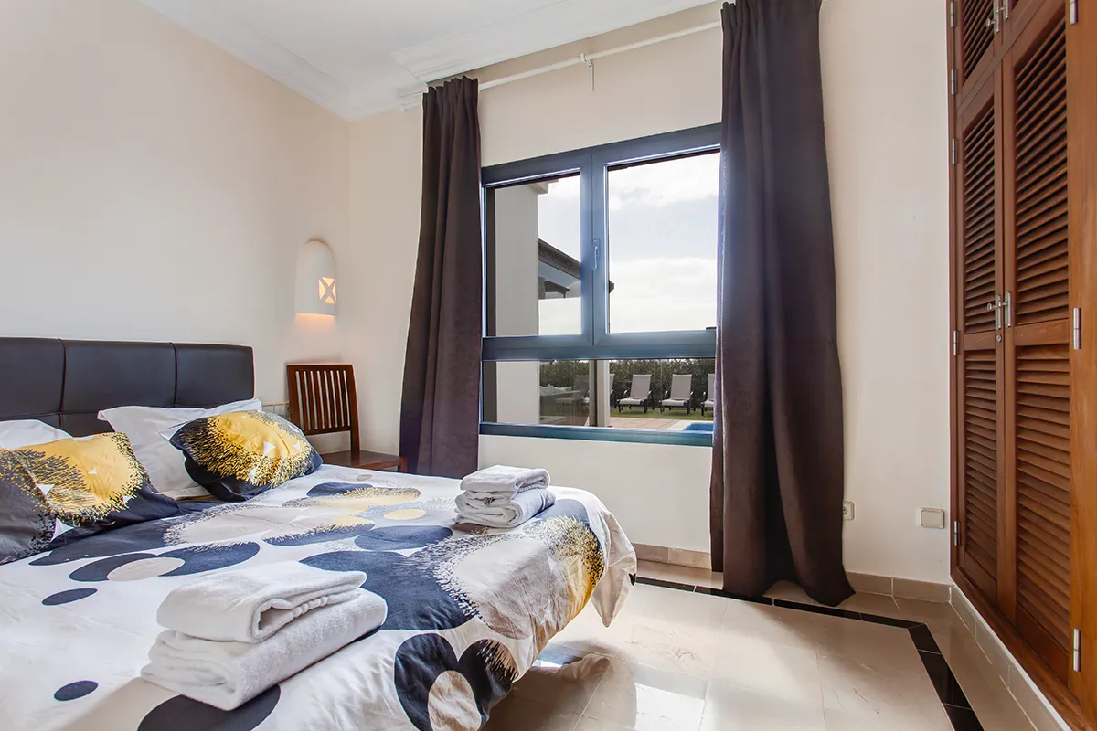 Bedroom overlooking the outdoor terrace at Hipoclub Villa Zafiro 34
