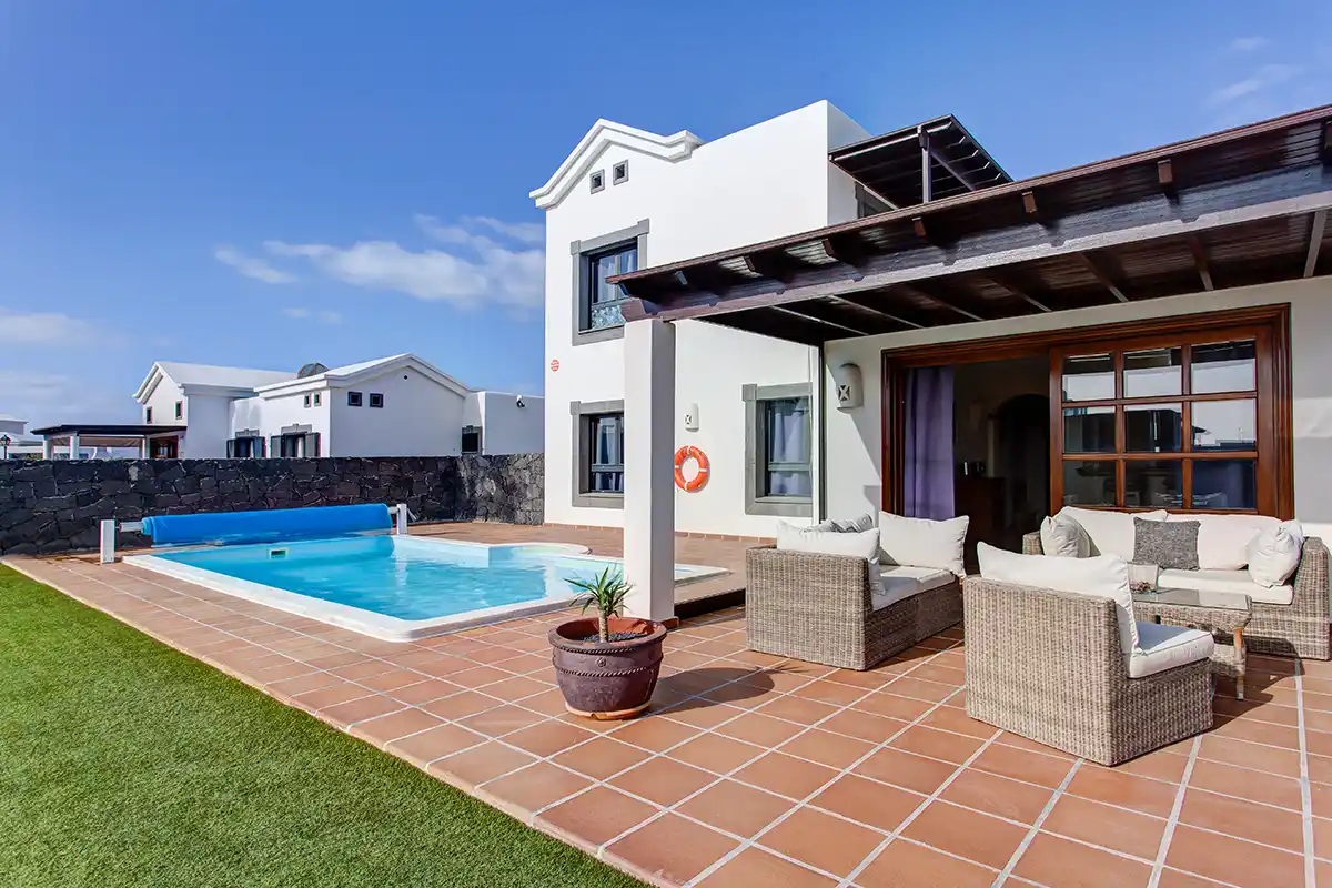 Outdoor terrace furnished with comfortable armchairs at Hipoclub Villa Zafiro 34