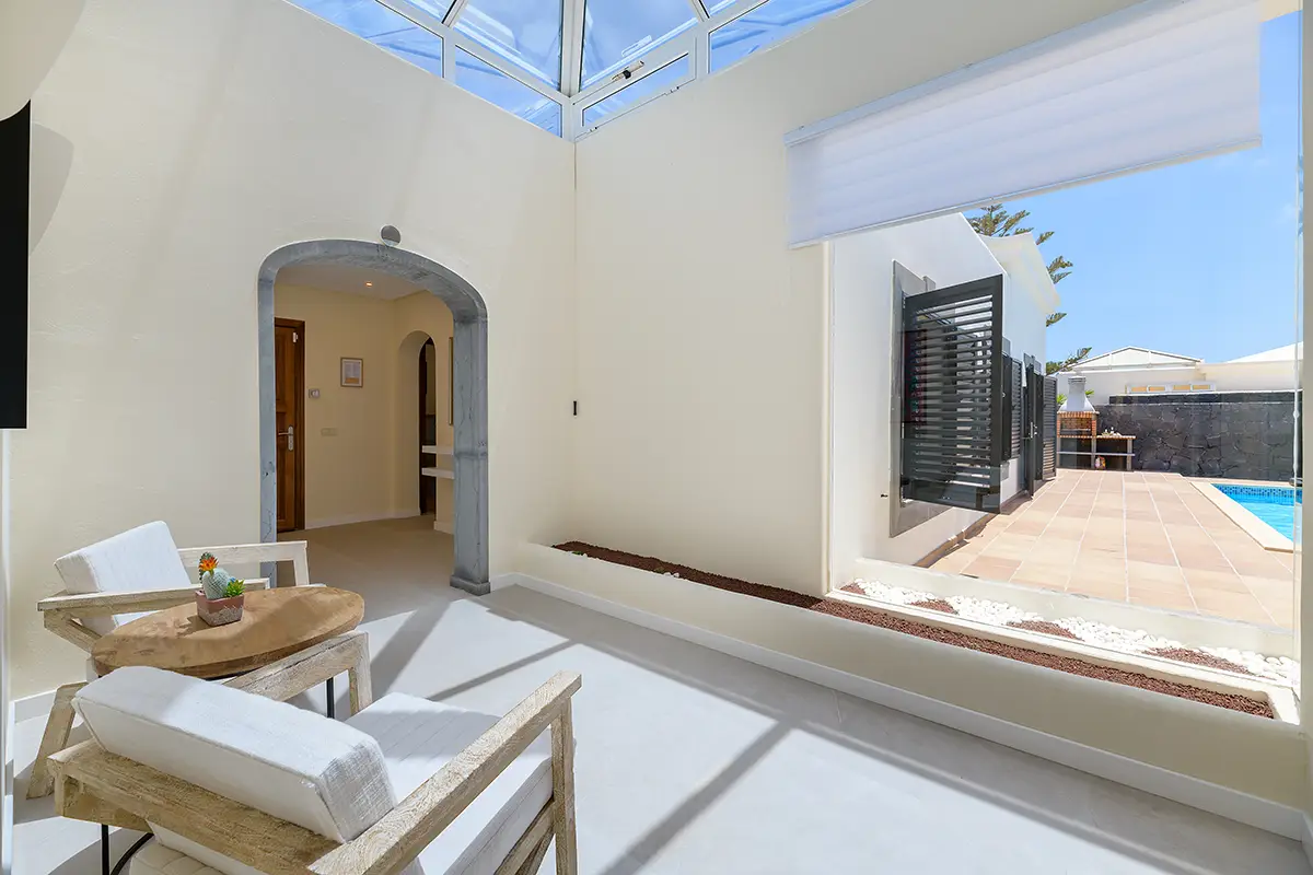 Hallway with glass wall facing the outdoor terrace at Villa Faro Park 189 Hipoclub