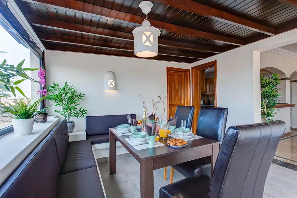 Dining table beside large window, Hipoclub Villa Aguamarina 2
