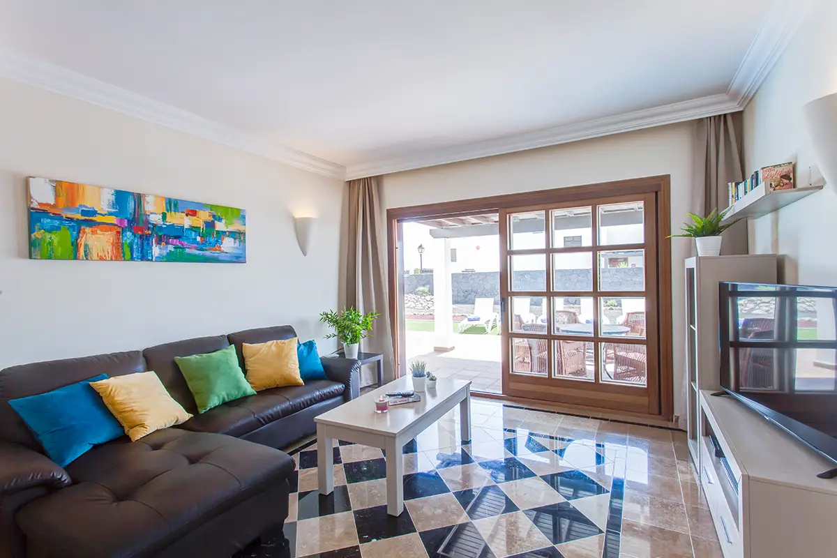 Bright living room with large sofa and TV, Hipoclub Villa Aguamarina 2